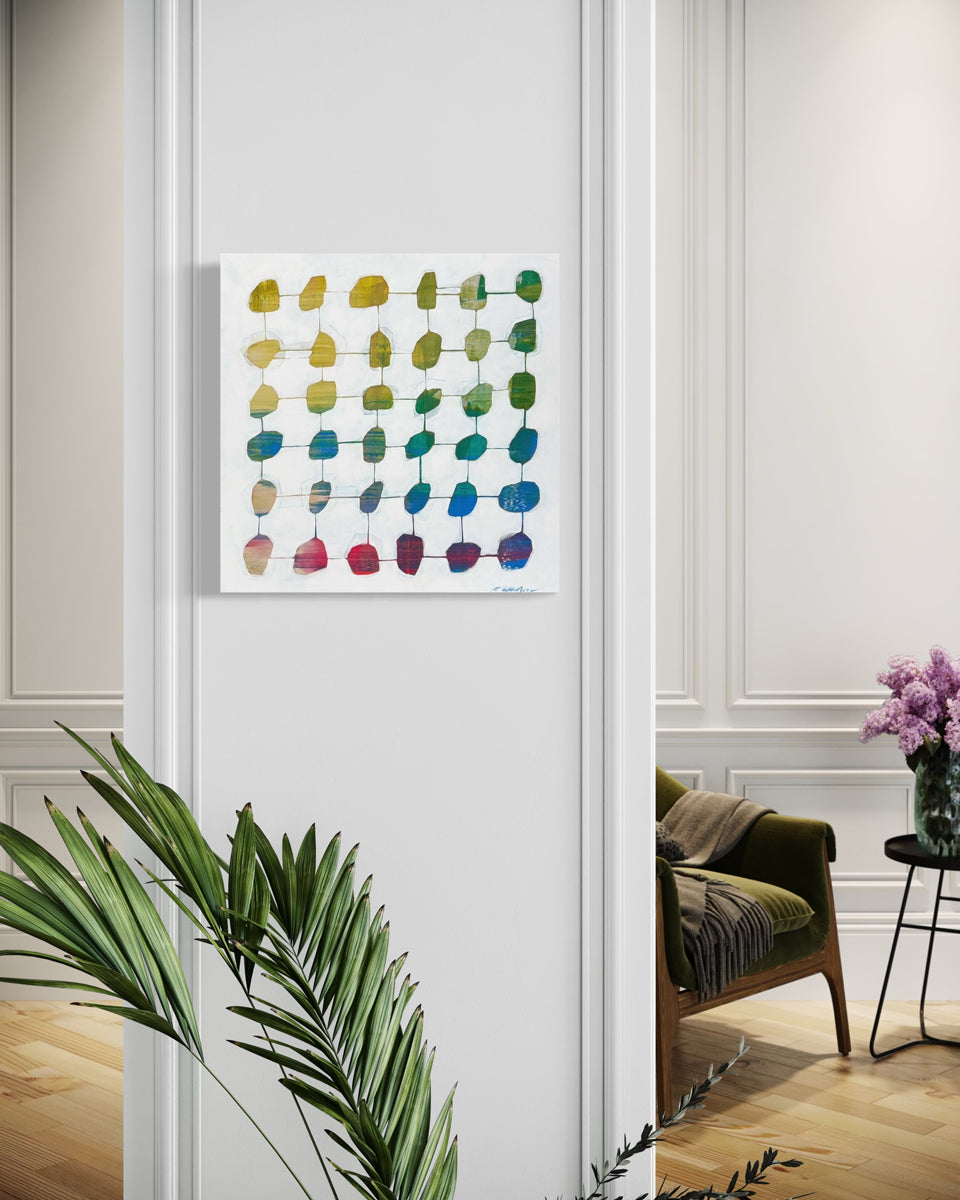 An abstract minimalist geometric painting hangs on a white wall with a plant beneath it and a green chair in the background. 