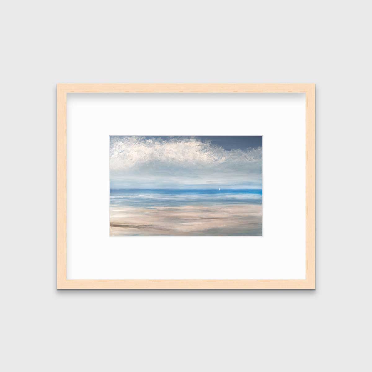 A blue, white and beige seascape print in a natural wood frame with a mat hangs on a white wall.