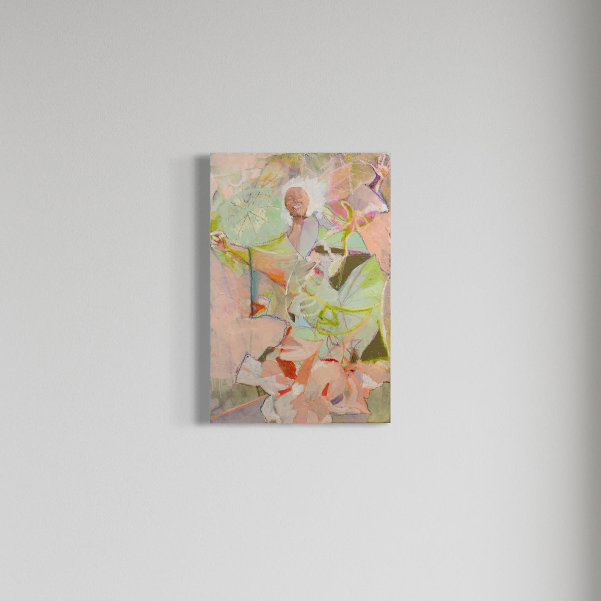 A pink abstracted figure painting hangs on a white wall. 