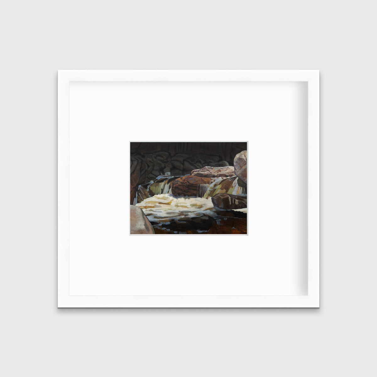 A brown, black and white abstract river landscape print in a white frame with a mat hangs on a white wall.