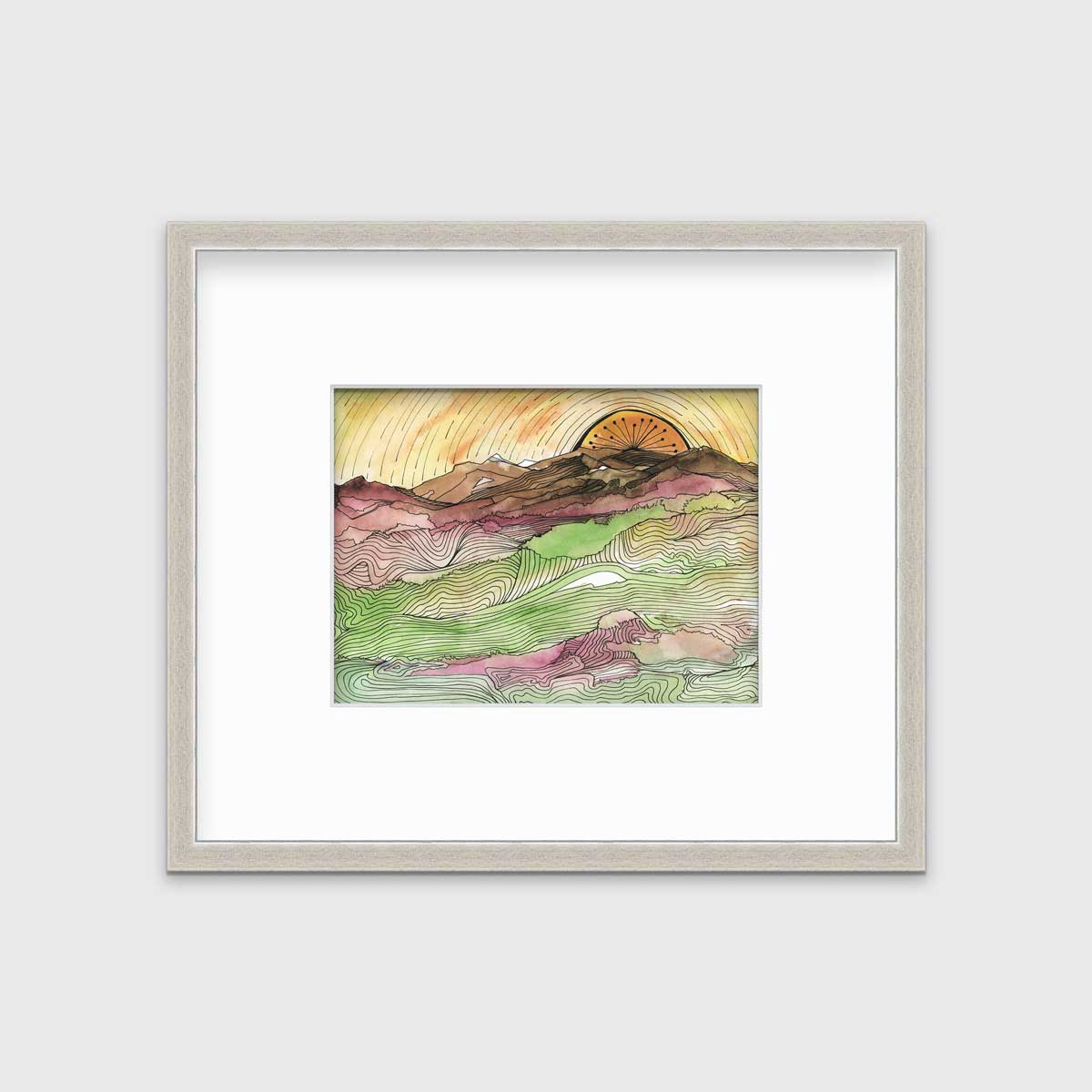 A yellow, brown, green and dark rose abstract landscape print with black outlines in a silver frame with a mat hangs on a white wall.