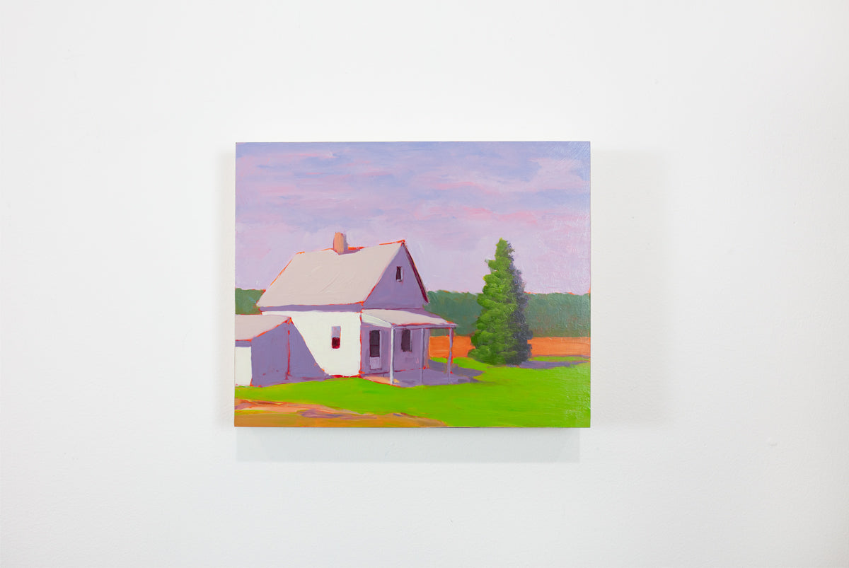 A small purple, green, and orange landscape painting hangs on a white wall. 