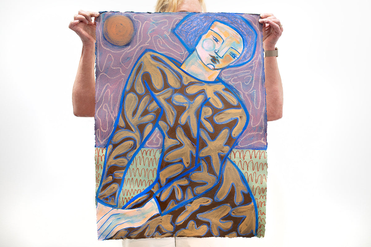 A woman holds a blue, brown, and purple painting of an abstracted figure in front of a white wall.  