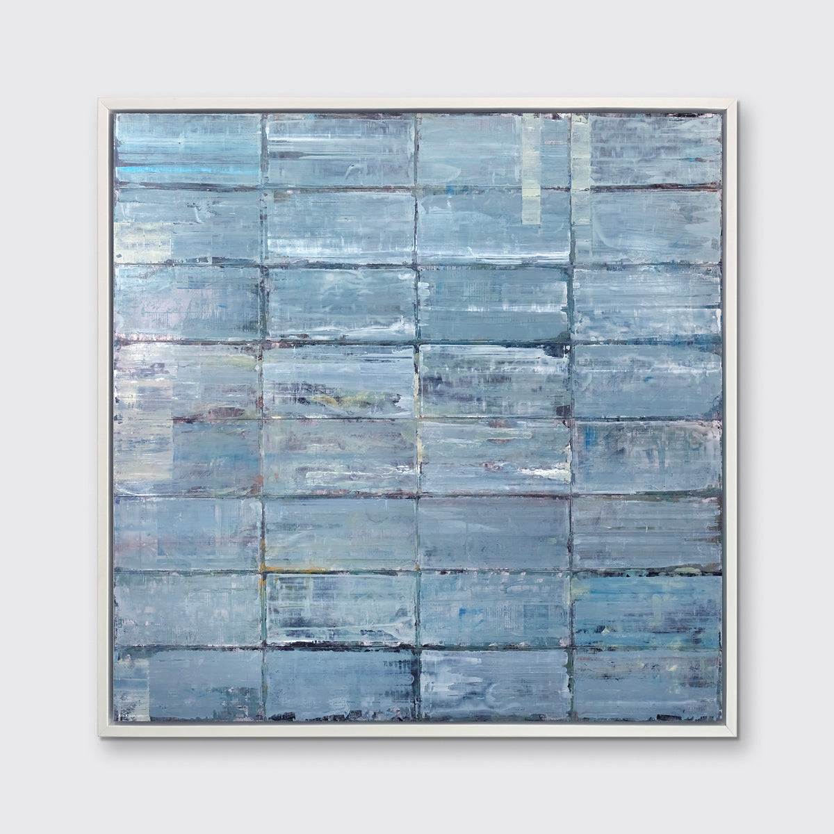 An abstract blue-green limited edition art print by Ned Martin  in a white frame hangs on a white wall.