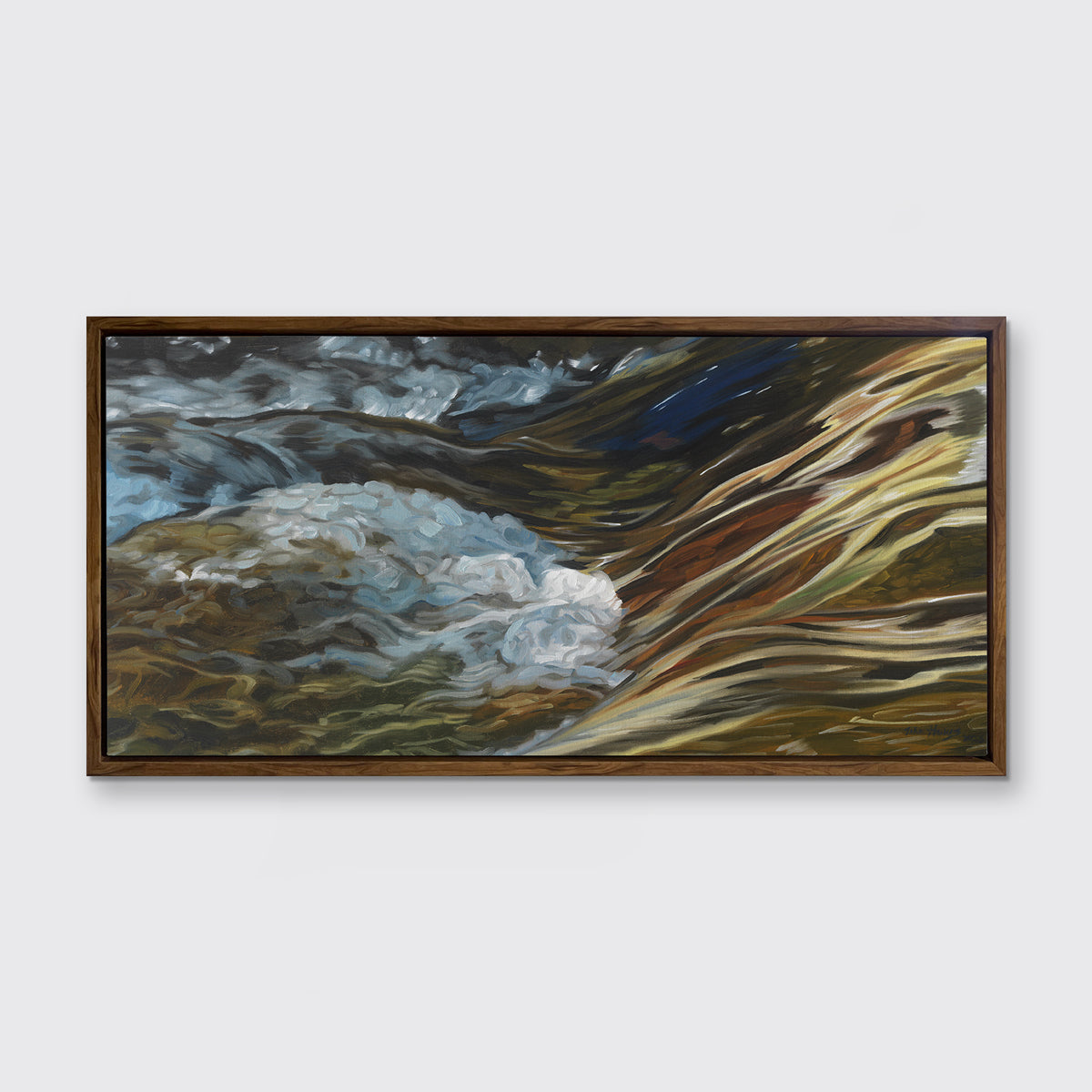 A painting of bubbling water flowing in a rocky river in a dark oak frame hangs on a white wall.
