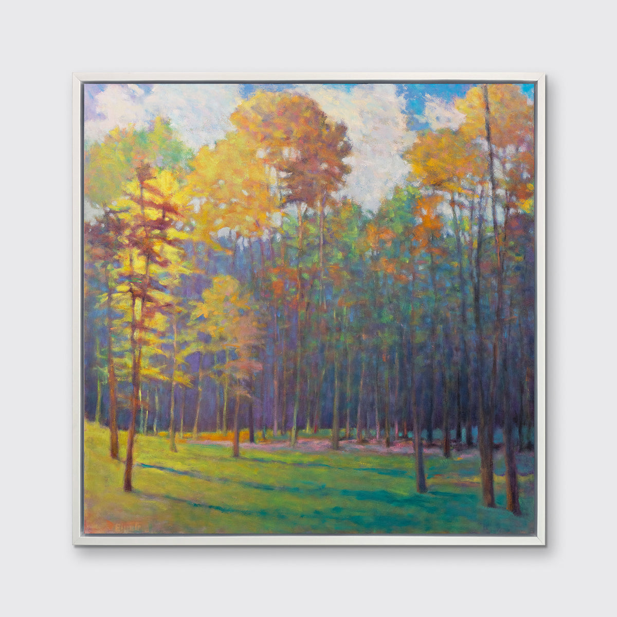 An impressionist landscape print in a white floater frame hangs on a white wall.