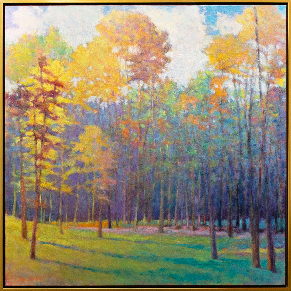 A colorful abstracted landscape painting framed in a thin gold floater frame.