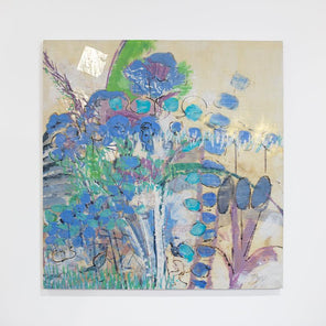 A blue and green abstracted encaustic painting hangs on a white wall.