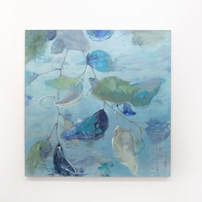 A blue abstract floral painting hangs on a white wall. 