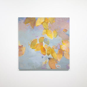 A blue and yellow gold abstract floral painting hangs on a white wall. 