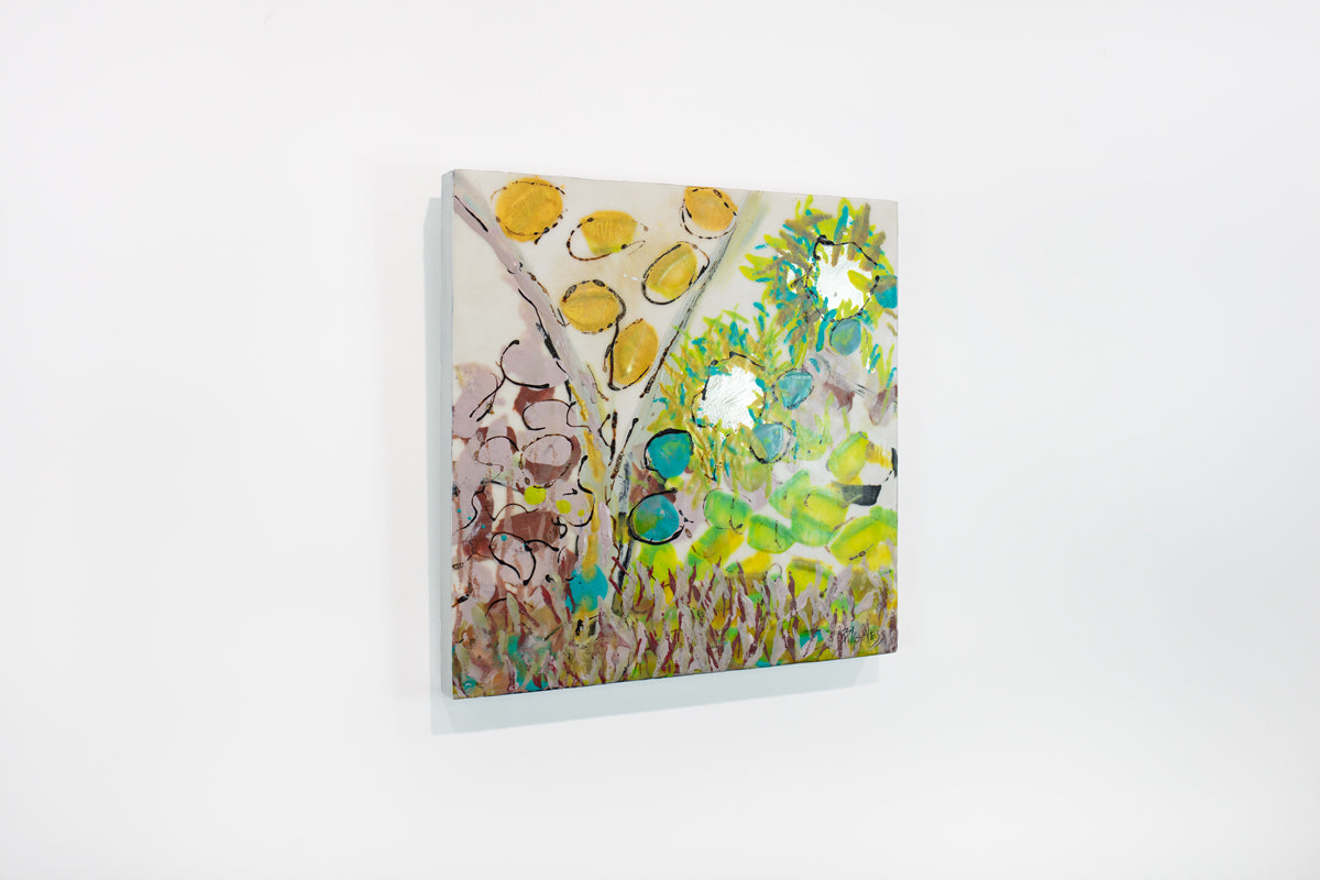 A yellow, green, and pink abstract painting hangs on a white wall.
