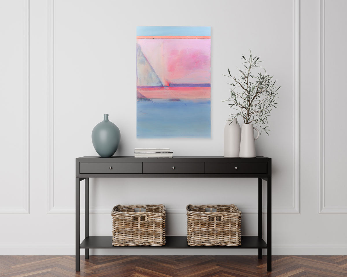 A pink and blue abstract painting hangs on a white wall above a black console table with modern table decor. 