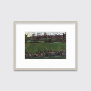 A green, brown and white abstract landscape print in a silver frame with a mat hangs on white wall.