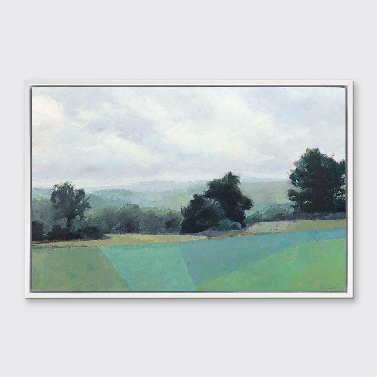 A landscape print in a white floater frame hangs on a white wall.
