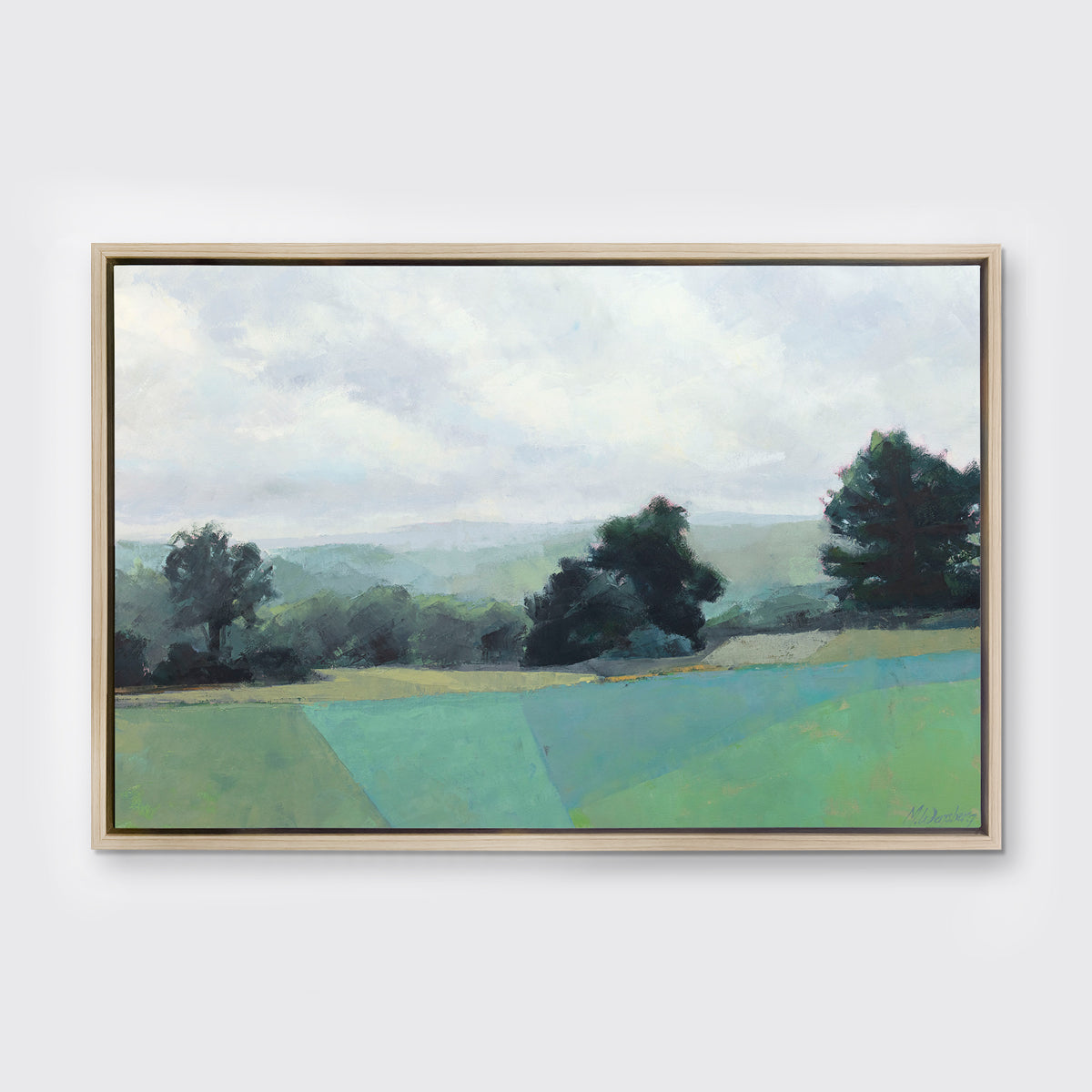 A landscape print in a white oak wood floater frame hangs on a white wall.