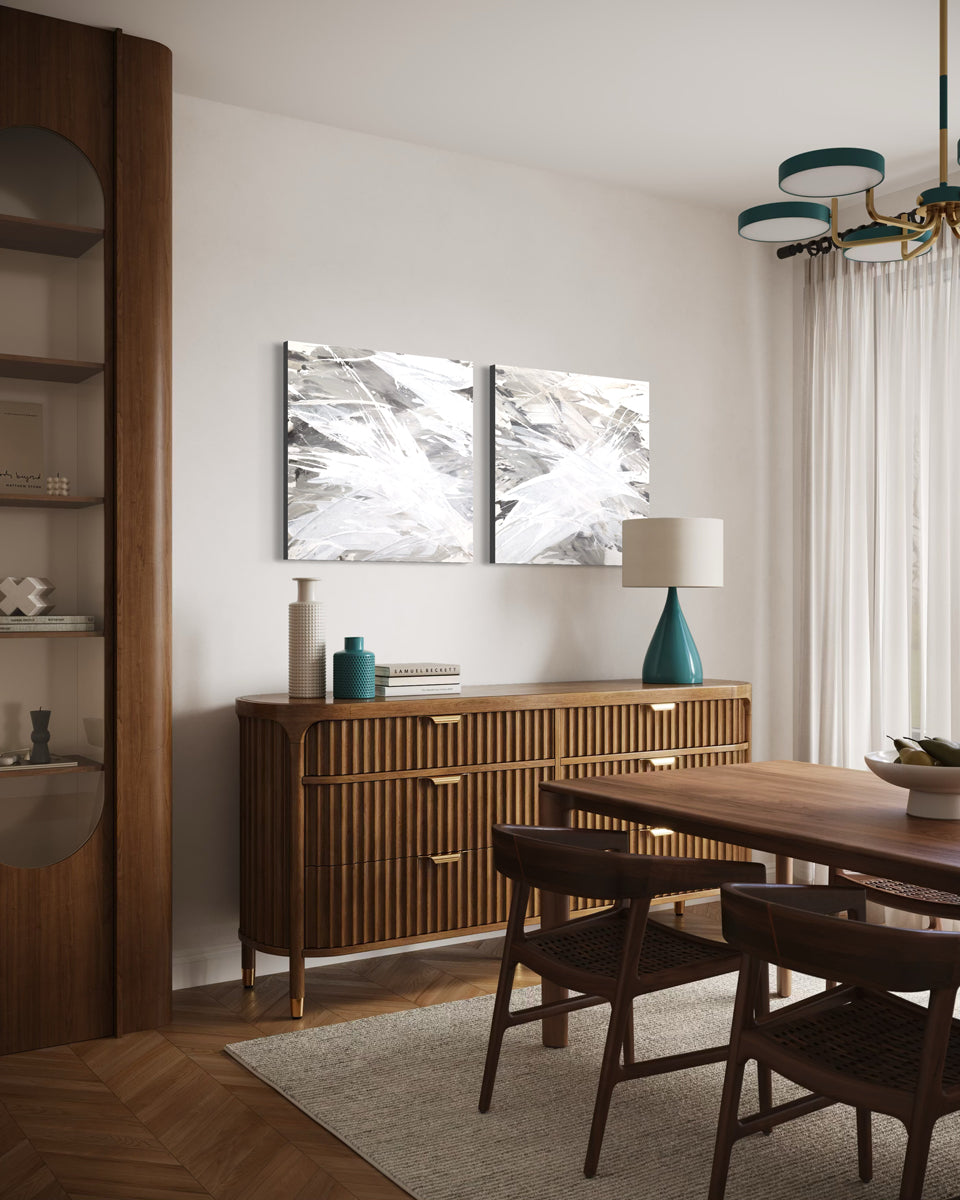 Dining room with wooden furniture, abstract art, and a lamp.