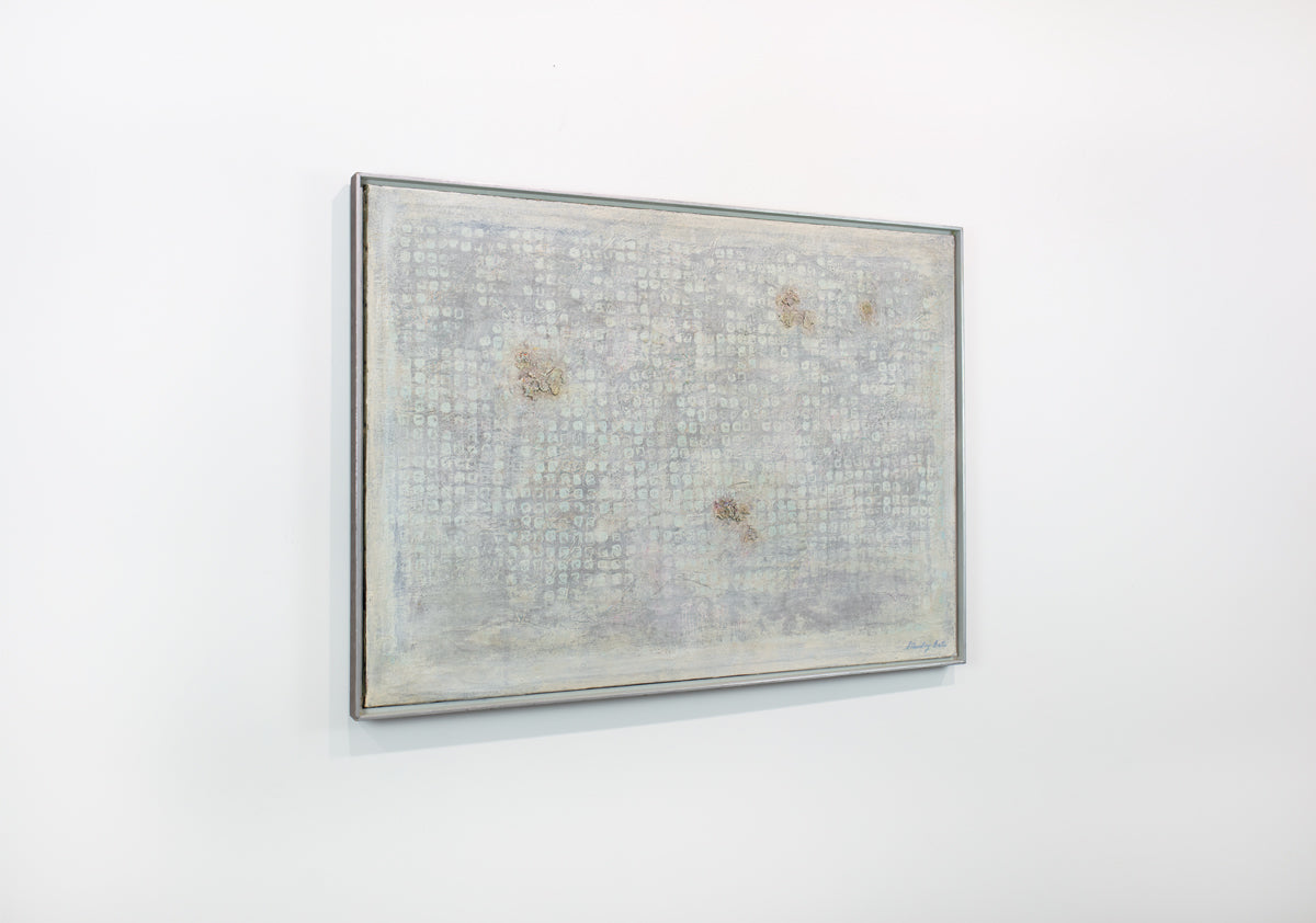 A light grey abstract painting hangs in a white floater frame on a white wall.