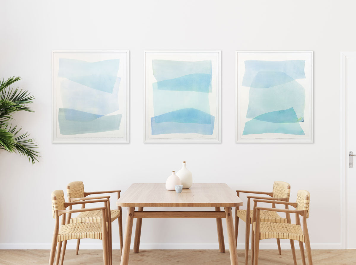 Hop Skip and Jump watercolor paintings are paired together above a dining room table.