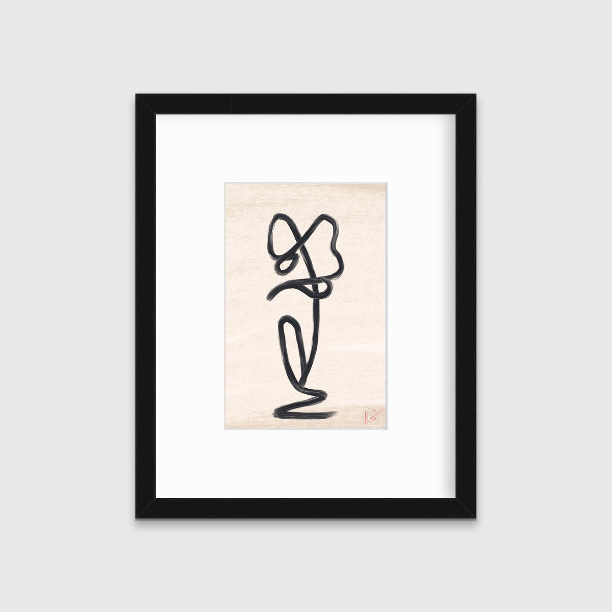A black minimalistic art print framed in a black frame hangs on a grey wall. 
