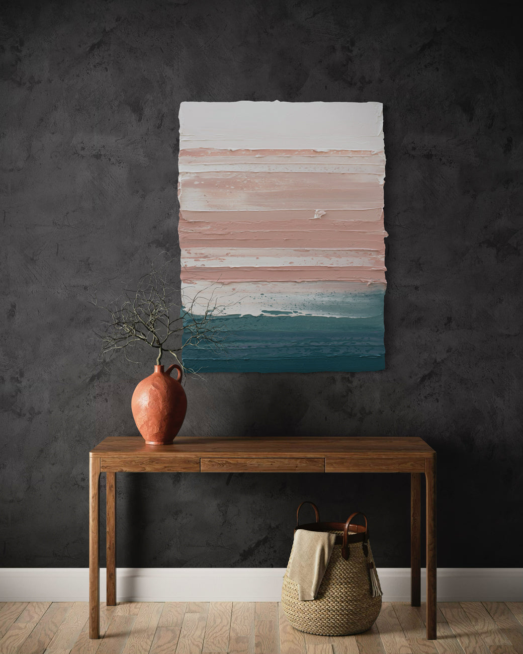 An original abstract painting by Teo Guererra on a dark wall above a wooden table with decorative items.