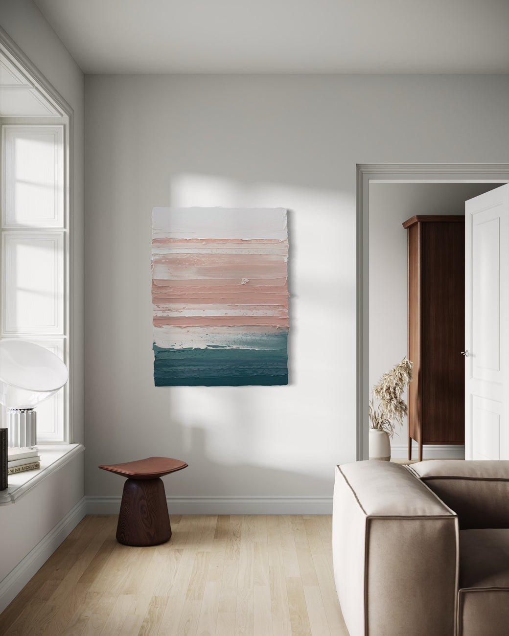 Modern living room with abstract painting on the wall, neutral decor, and a side table.