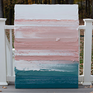 A peach, coral, white and teal with lavender thick textured painting leaning outside on a deck in natural light by Teodora Guererra.