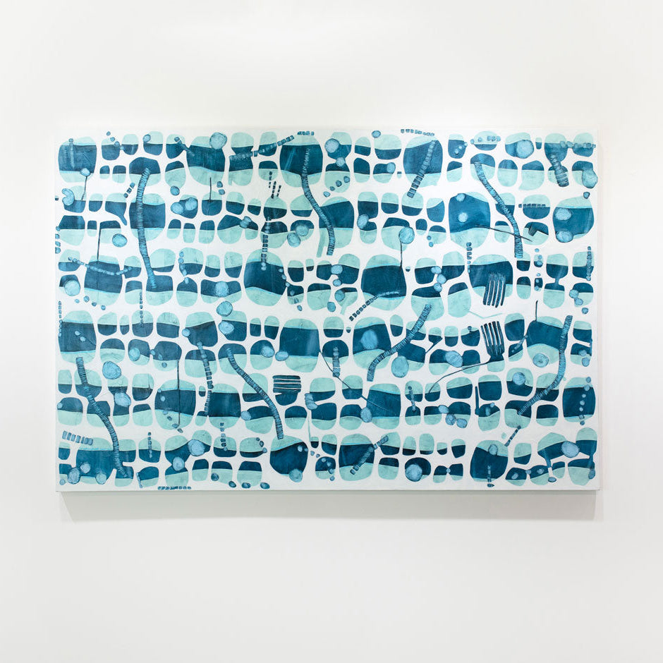 A blue and white abstract painting hangs on a white wall. 