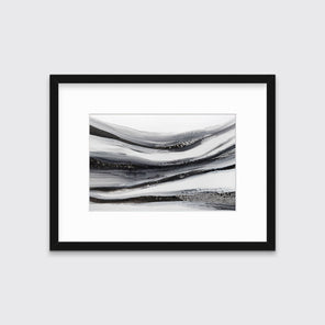 A black, white and grey abstract print in a black frame with a mat hangs on a white wall.