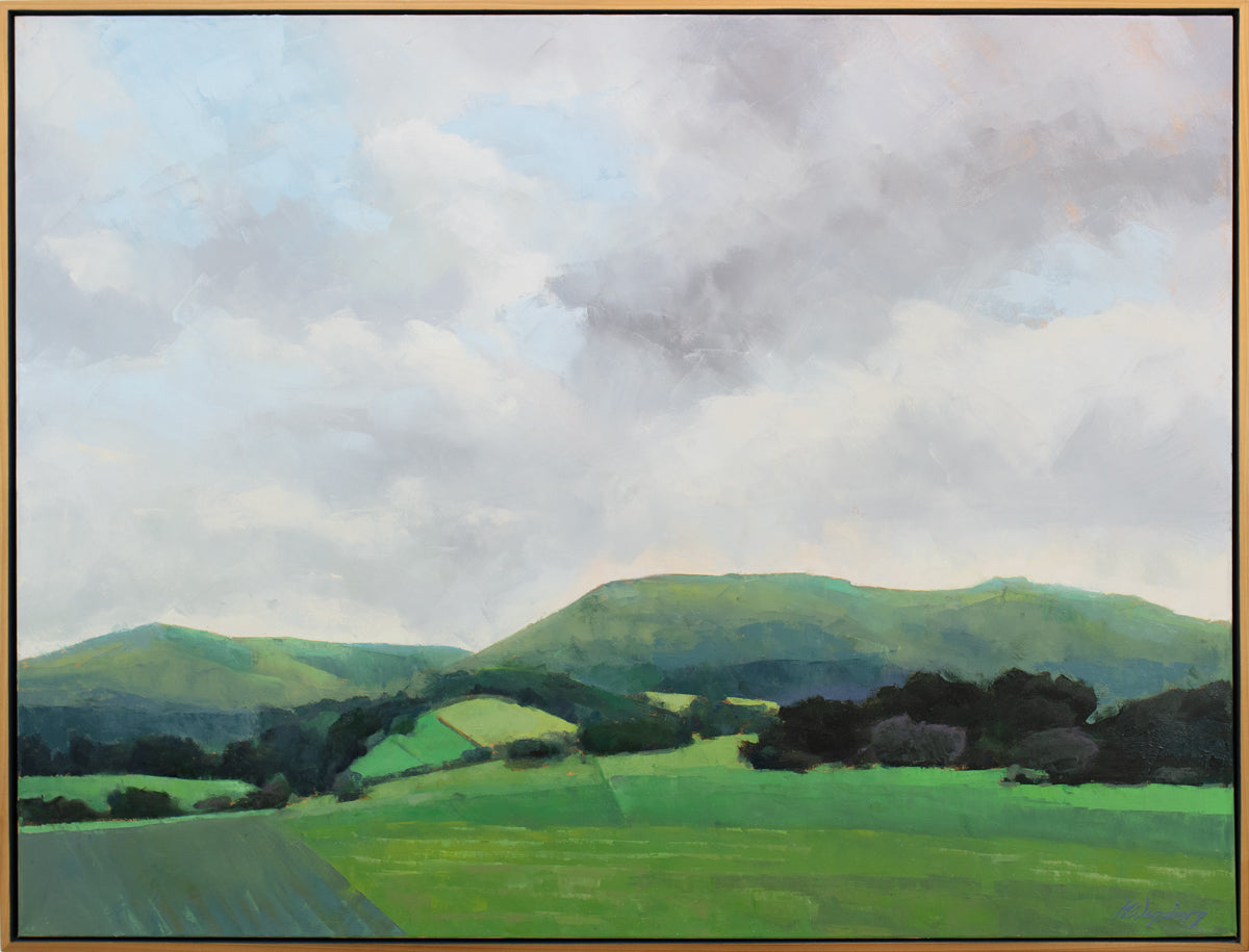 A light grey and shades of green landscape painting by Molly Doe Wensberg in a light wood floater frame.