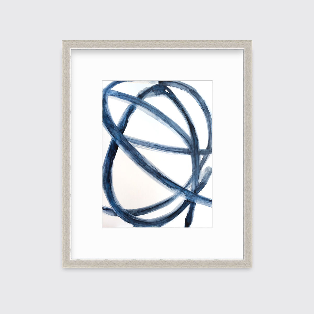 A blue and white abstract print in a silver frame with a mat hangs on a white wall.
