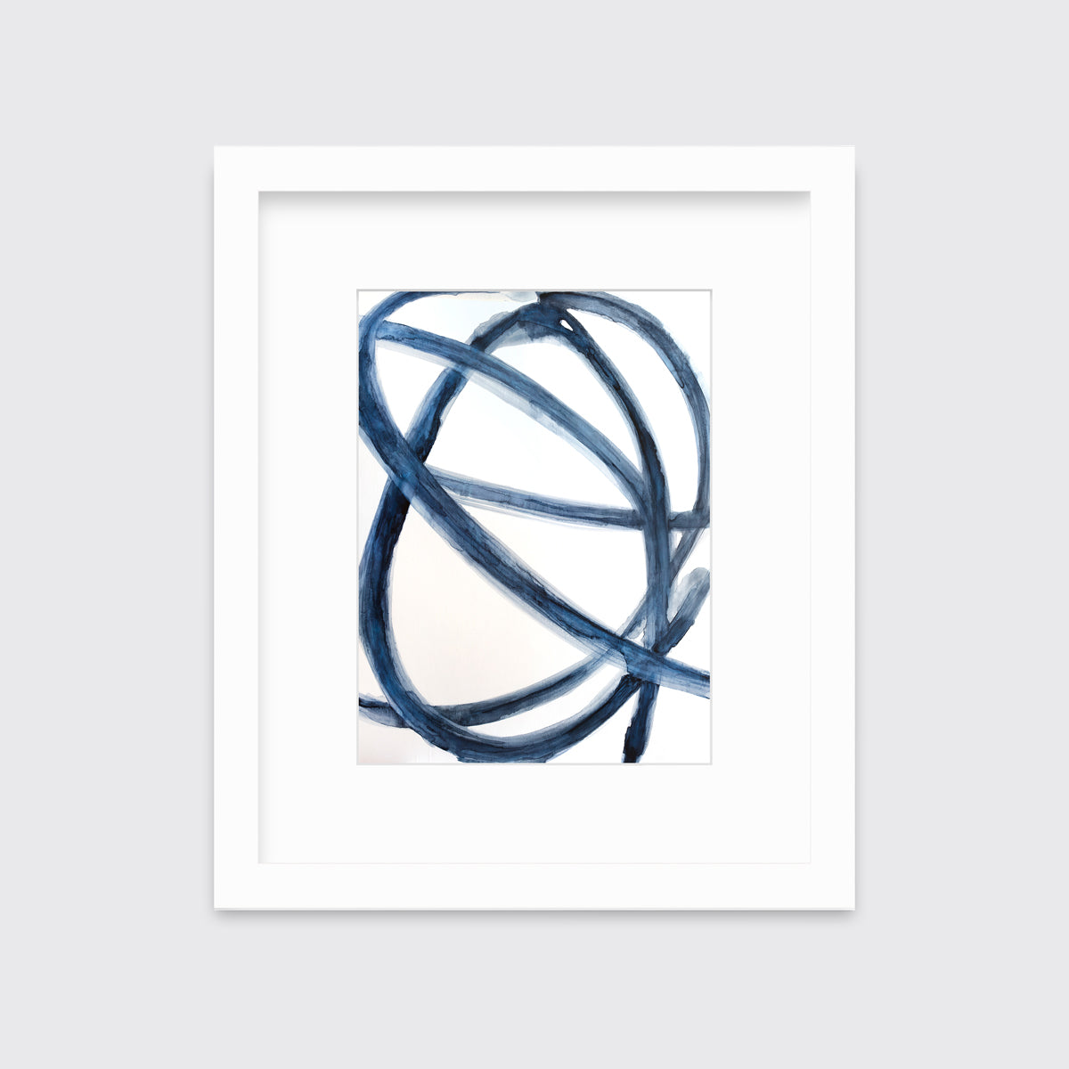 A blue and white abstract print in a white frame with a mat hangs on a white wall.