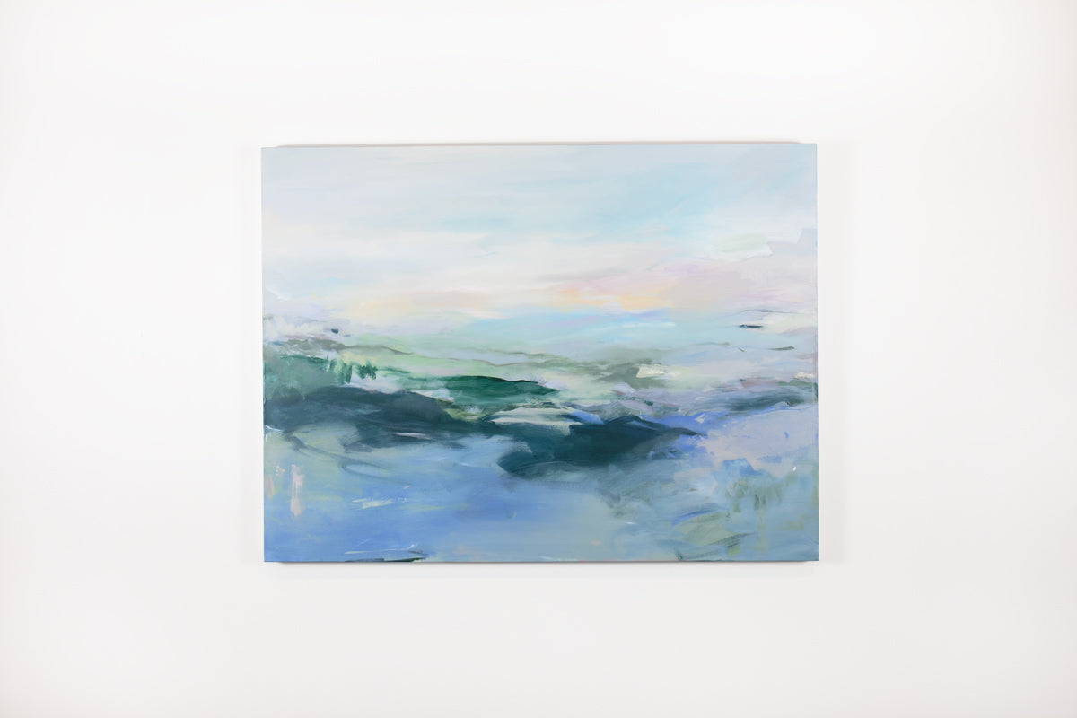 A blue, pink, and green abstract painting hangs on a white wall. 