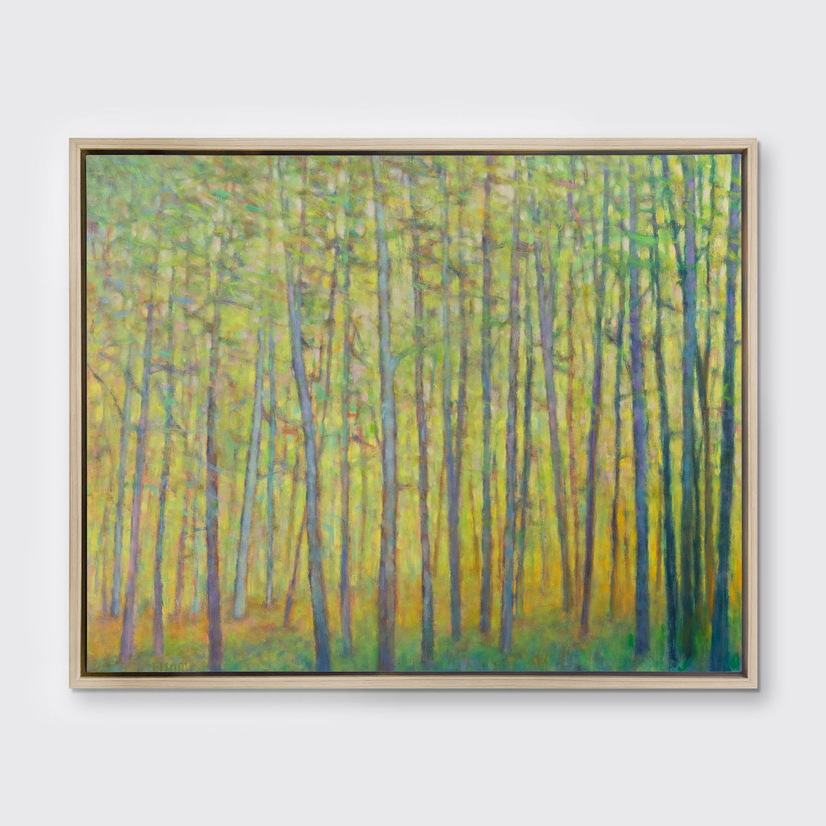 A green and yellow impressionist landscape print in a white oak wood floater frame hangs on a white wall.