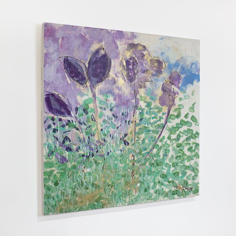 A green, blue, and violet abstracted floral painting hangs on a white wall.