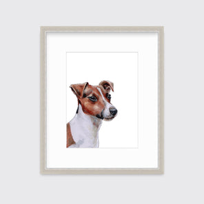 An illustration of a Jack Russell dog framed in a silver frame hangs on a white wall.
