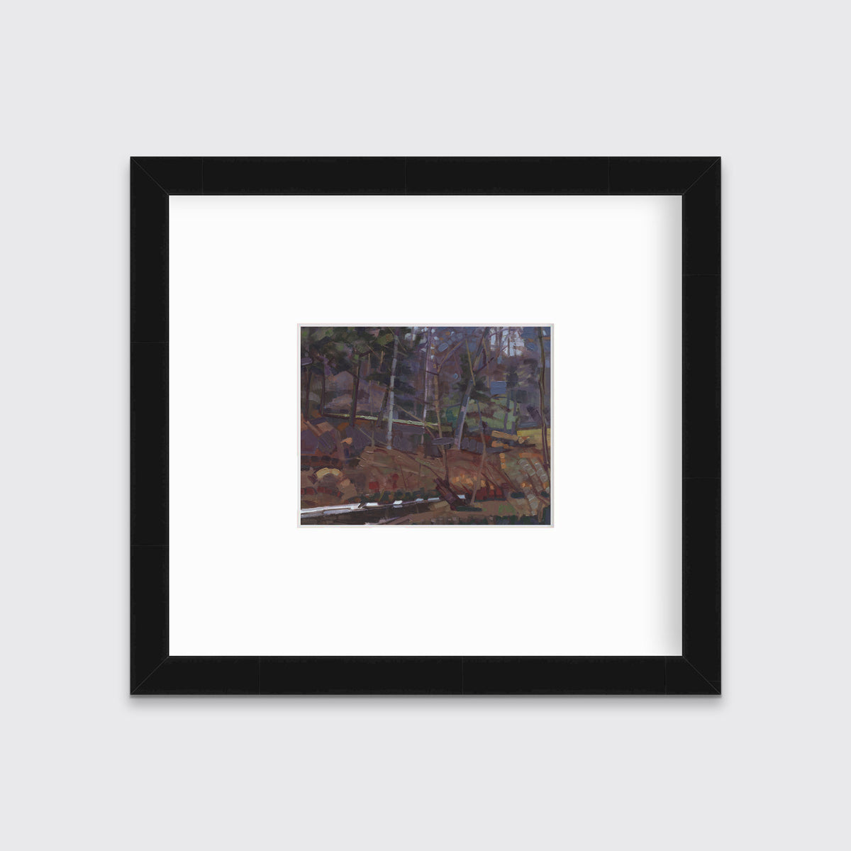 A brown, grey and green abstract landscape print in a black frame with a mat hangs on a white wall.