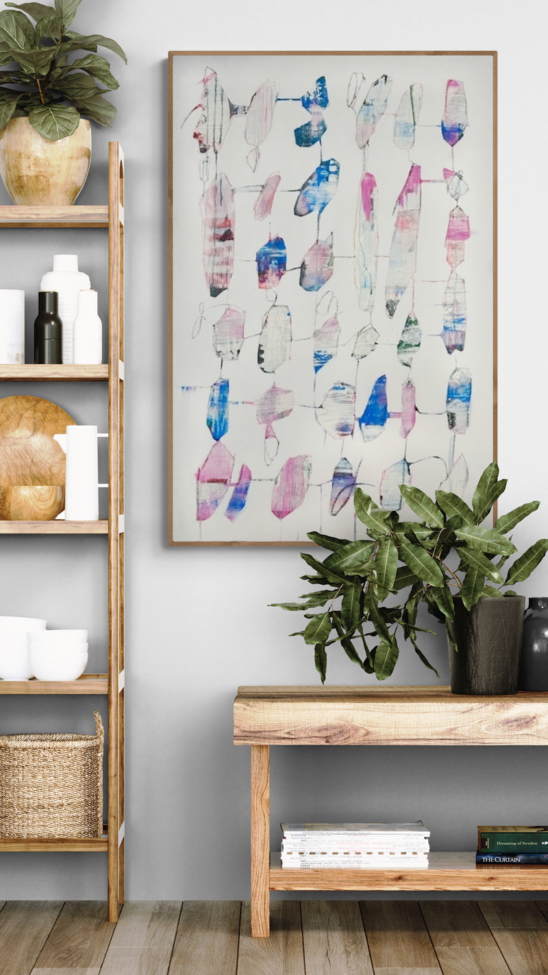 Modern interior with a wooden shelf, plant, and abstract art on a gray wall.