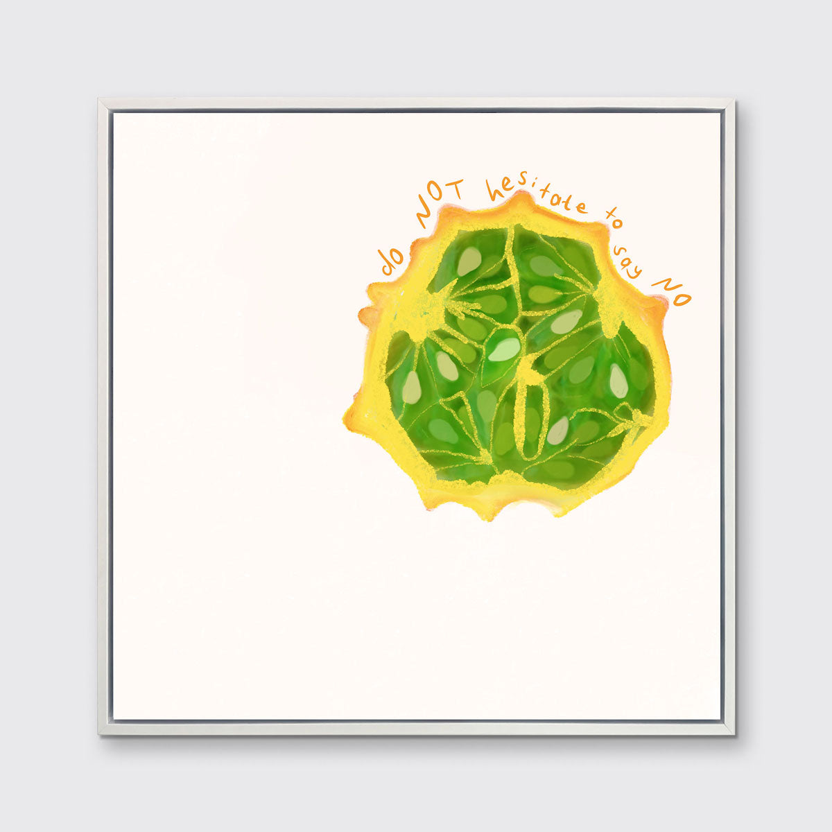 An abstract print of a fruit framed in a white floater frame hangs on a light wall.