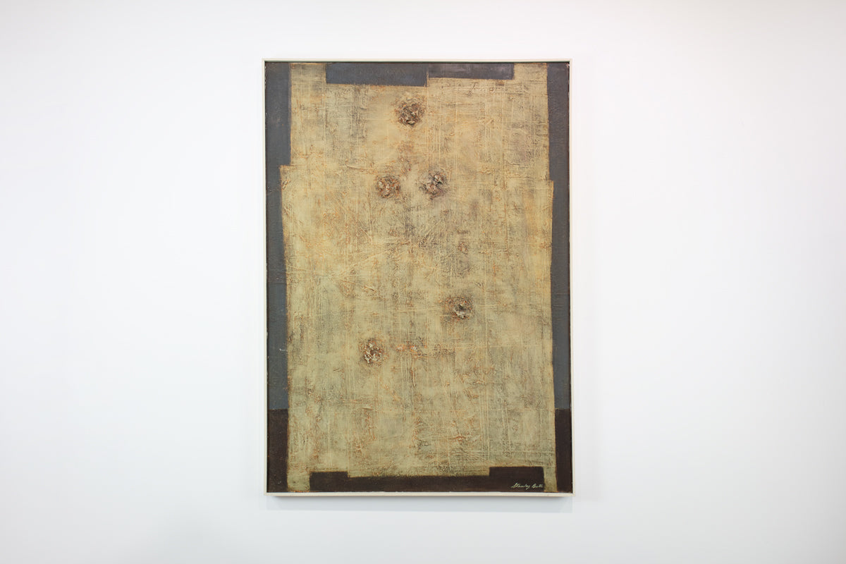 A grey and yellow-beige abstract painting hangs on a white wall. 