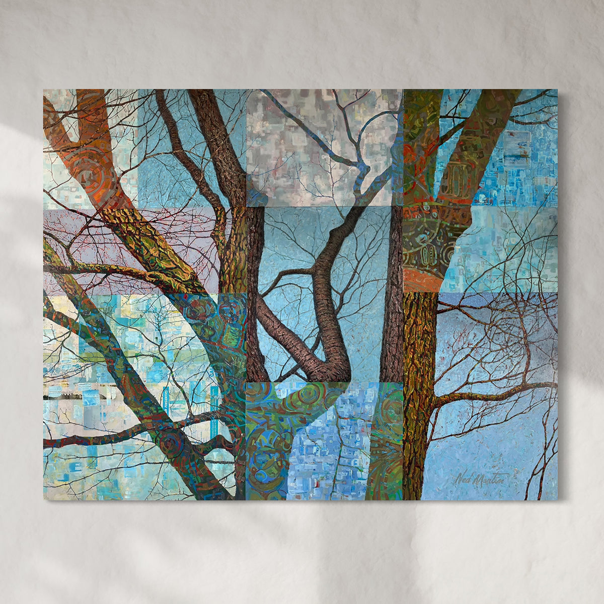 An original oil painting painting on wood and metal depicting trees with a patchwork of colors hanging on a light gray wall.