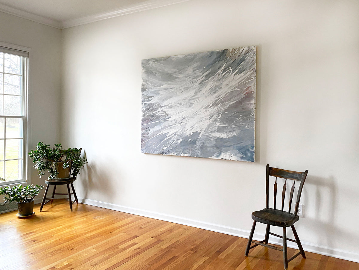 Teo Guererra's studio room with one of her large abstract paintings on the wall, wooden floor, and two chairs.