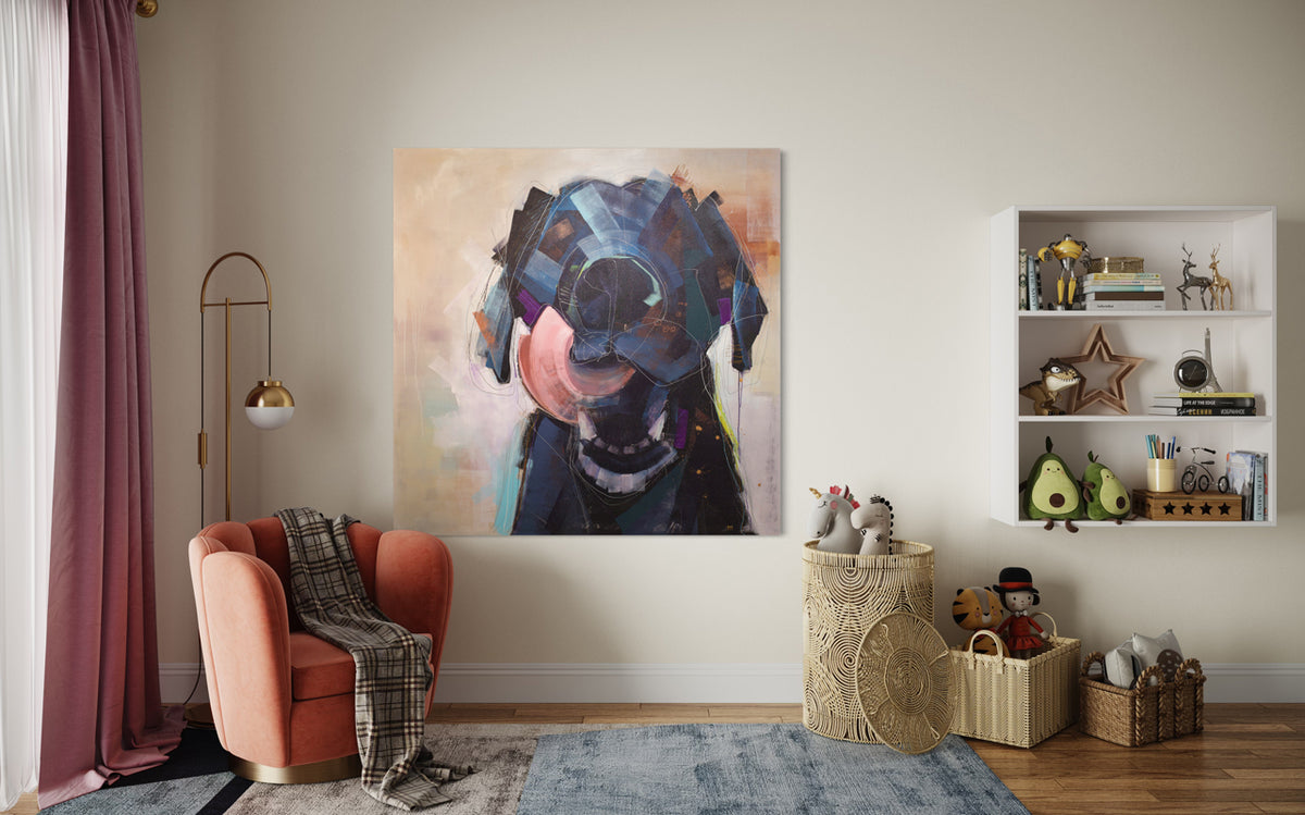 A painting of an abstracted black dog with an open mouth and tongue curled out by Russell Miyaki hangs on a white wall above a orange chair with a plaid throw blanket, a rattan hamper with stuffed animals and a built-in bookshelf with decorative accessories.