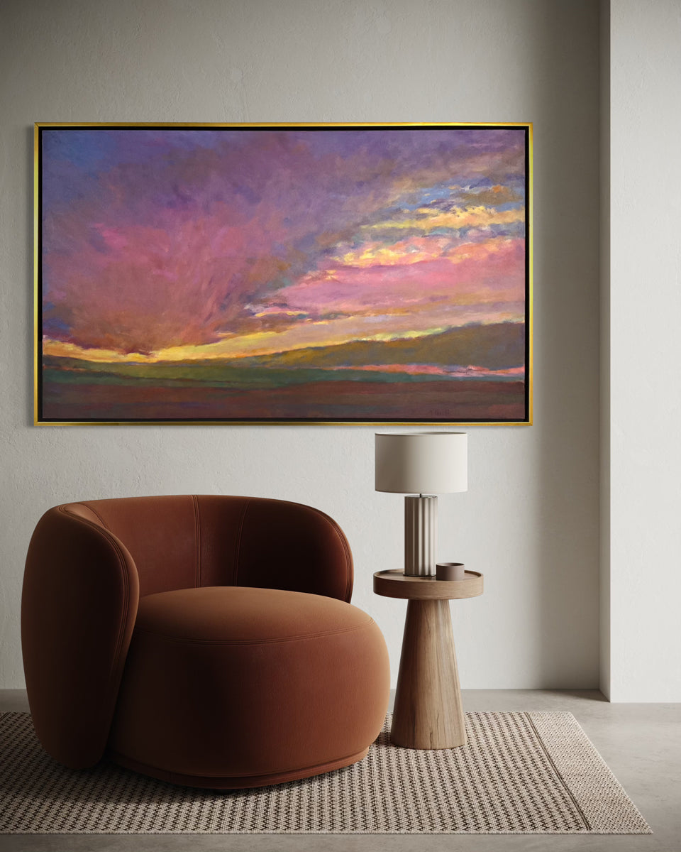Modern interior with a brown armchair, side table, and colorful abstract painting on the wall.