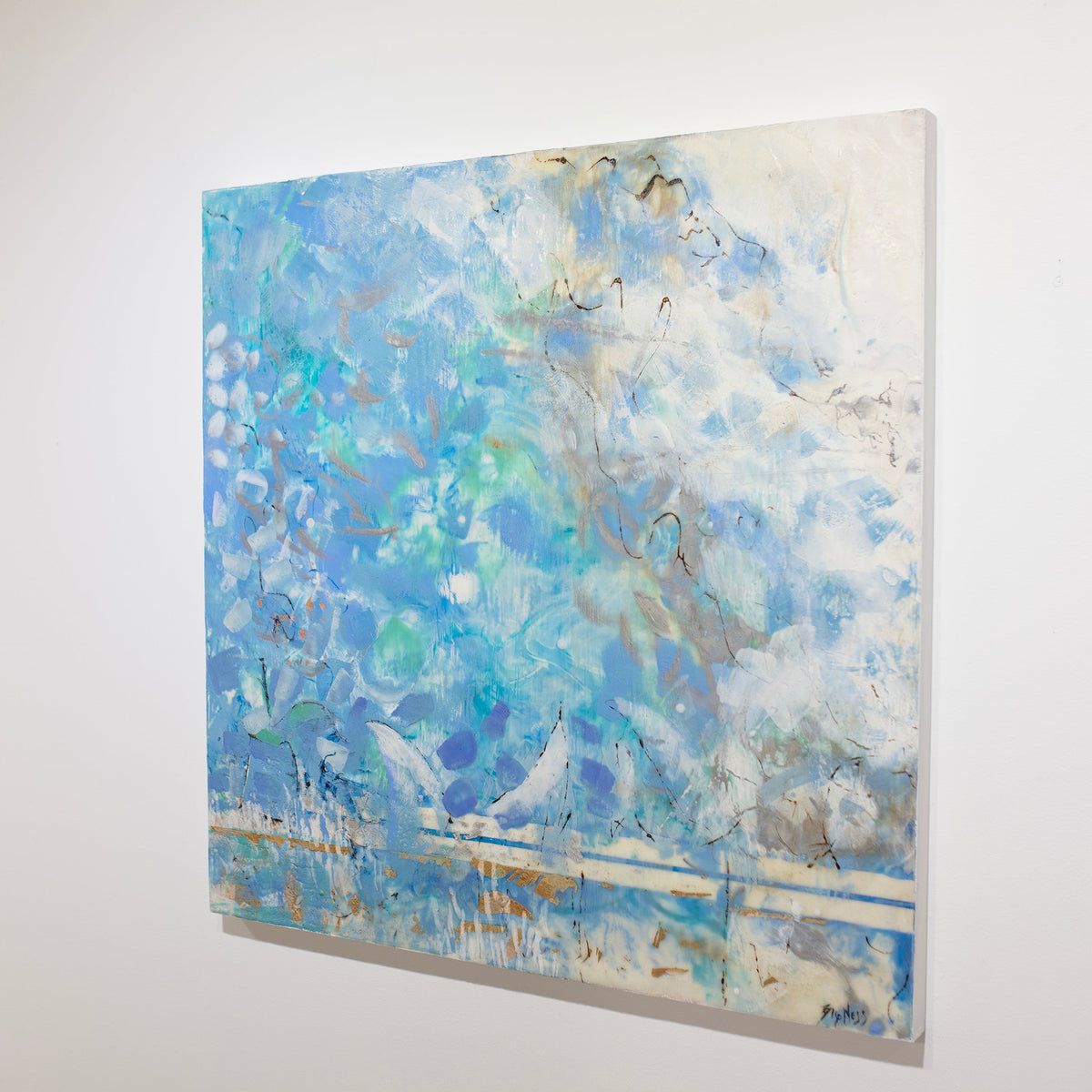 An encaustic painting with blue and turquoise marks is hung on a gallery wall. side view.