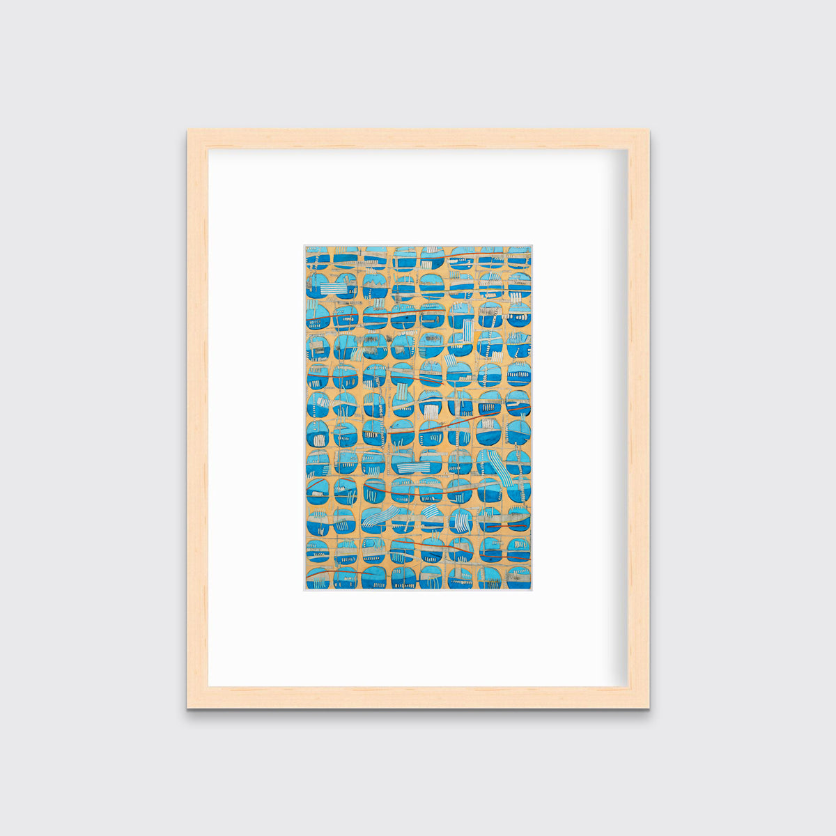 An orange, blue and light blue abstract print in a natural wood frame with a mat hangs on a white wall.