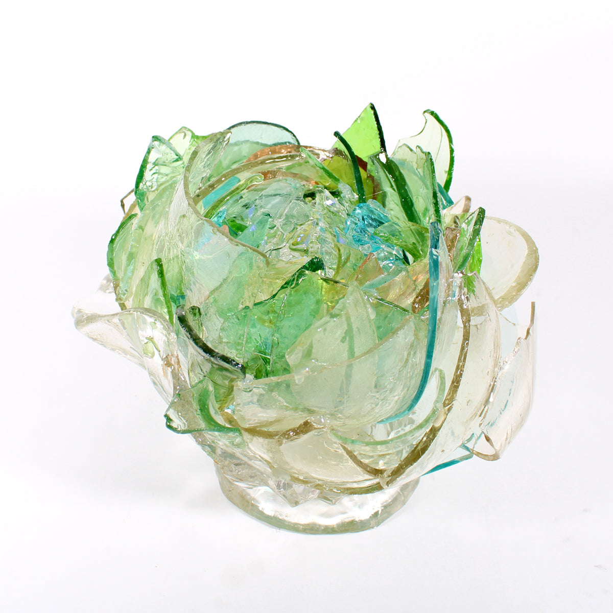 Glass sculpture with green and clear colors on a white background.
