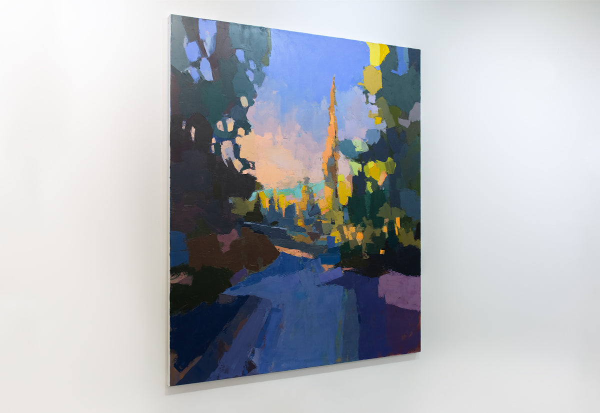 A blue and yellow abstracted landscape painting hangs on a white wall.