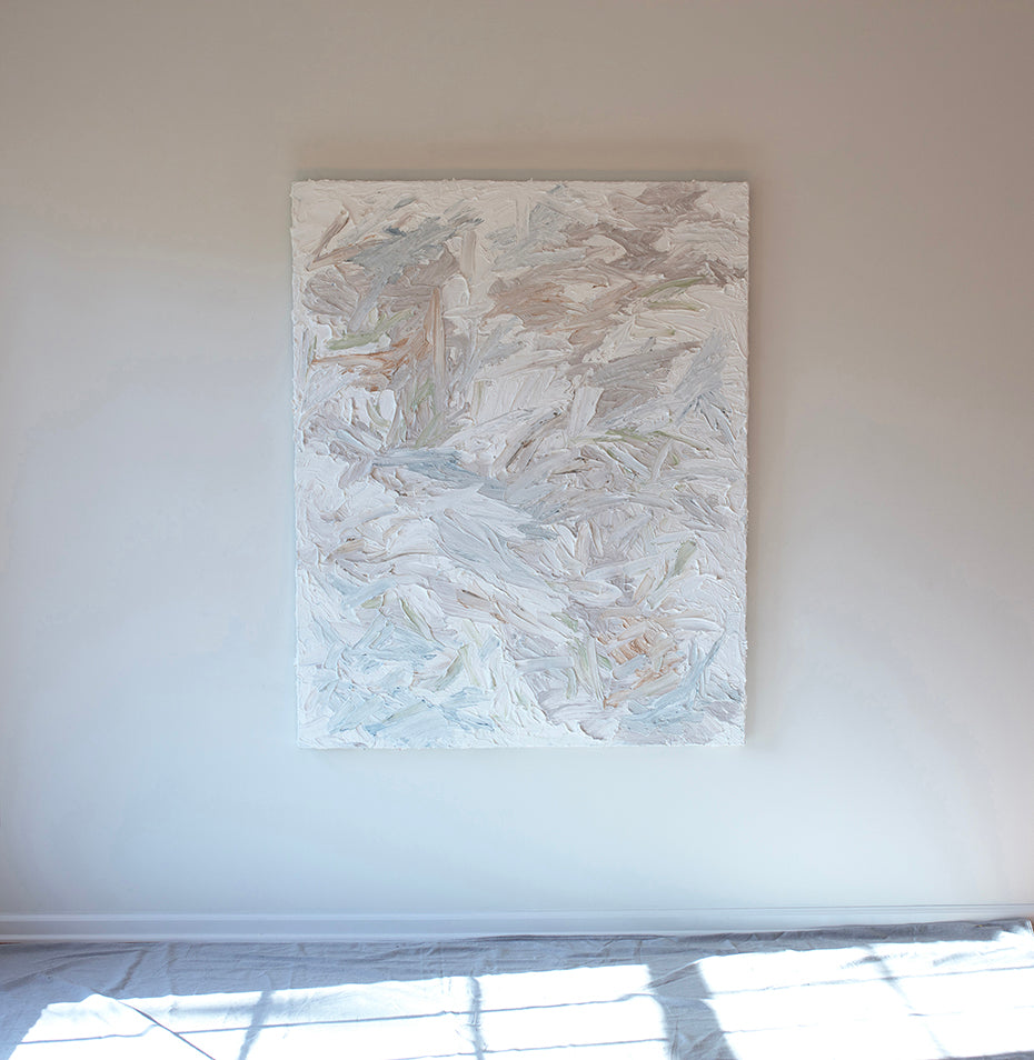 A thick textured impasto abstract painting with large brush strokes hanging on the artists studio wall.