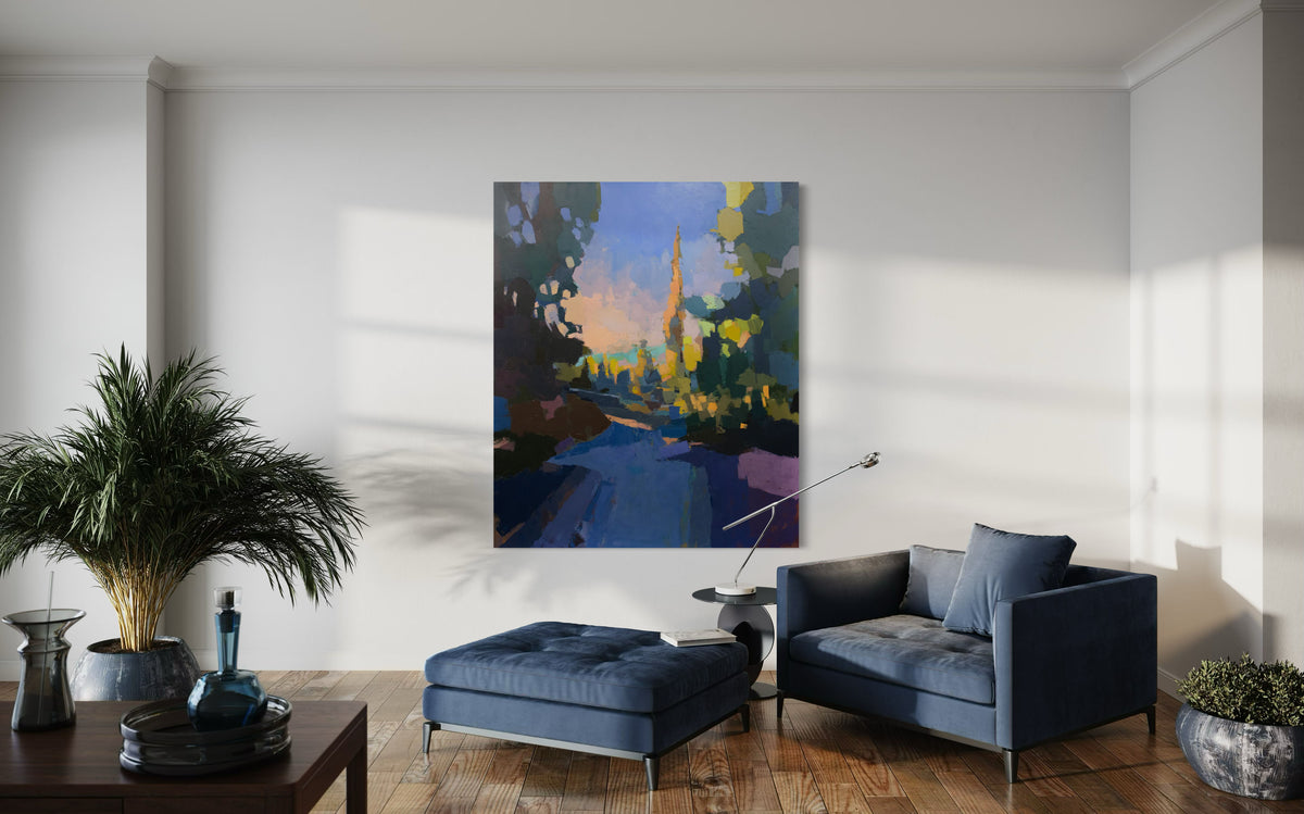 A large blue and yellow abstracted landscape painting hangs on a white wall above a blue chair.