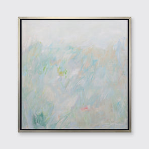 A light teal, light green and beige abstract print in a silver floater frame hangs on a white wall.